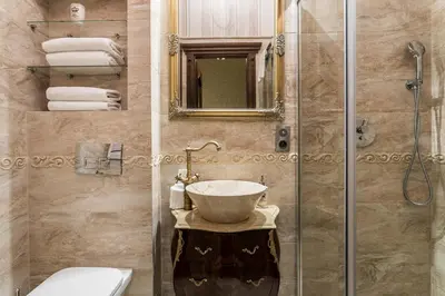 a bathroom with a sink and a shower at Exclusive Royal Apartments in Kraków