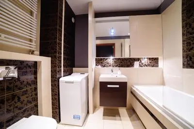 a bathroom with a sink and a toilet and a tub at Apartments of Pawia in Kraków
