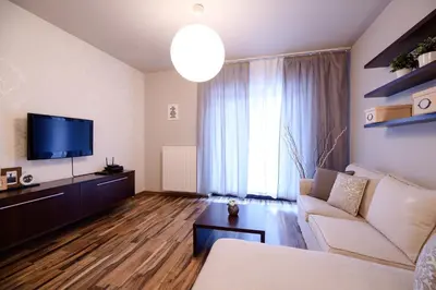 a living room with a couch and a flat screen tv at Apartments of Pawia in Kraków