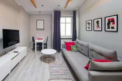 a living room with a couch and a table at Central & comfortable apartment in Kraków