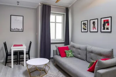 a living room with a couch and a table at Central & comfortable apartment in Kraków