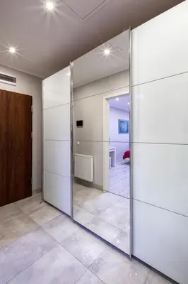 a sliding glass door in a room with a mirror at Central & comfortable apartment in Kraków