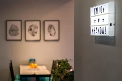 a room with three pictures on the wall and a sign at Elegant apartment 5 minutes from Wawel Castle in Kraków