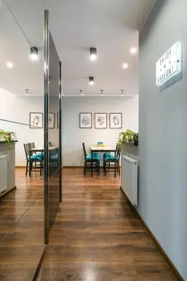 a dining room with a table and chairs at Elegant apartment 5 minutes from Wawel Castle in Kraków