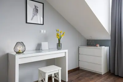 a room with a white desk and a stair case at Elegant apartment 5 minutes from Wawel Castle in Kraków