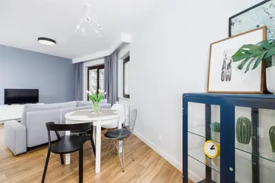 a living room with a table and a couch at Apartament 3d Wilga by Noclegi Renters in Kraków