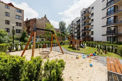 a playground with a swing set in a park at Apartament 3d Wilga by Noclegi Renters in Kraków
