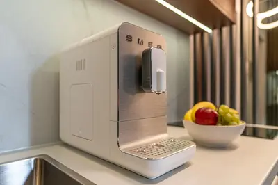 a computer on a counter with a bowl of fruit at Dasto Jacuzzi Old Town Cracow in Kraków