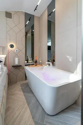 a bathroom with a large white tub in a room at Dasto Jacuzzi Old Town Cracow in Kraków