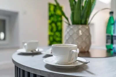two cups and saucers sitting on a table at Dasto Jacuzzi Old Town Cracow in Kraków