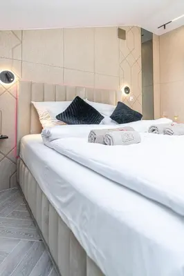 two large white beds in a room at Dasto Jacuzzi Old Town Cracow in Kraków
