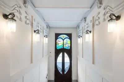 a hallway with a door with a stained glass window at Old Town Apt - Bosacka B30 in Kraków