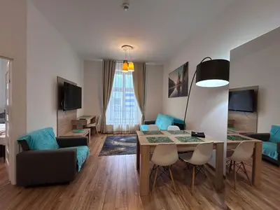 a living room with a couch and a table and chairs at Old Town Apt - Bosacka B30 in Kraków