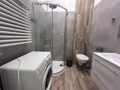a washing machine in a bathroom with a shower at Old Town Apt - Bosacka B30 in Kraków