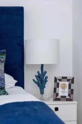 a bedroom with a bed with a blue head board at Dietla Apartament z Klimatyzacją i Balkonem w Centrum Krakowa by Noclegi Renters in Kraków