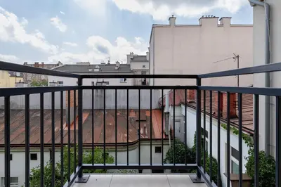 a balcony with a view of a city at Dietla Apartament z Klimatyzacją i Balkonem w Centrum Krakowa by Noclegi Renters in Kraków