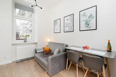 a living room with a couch and a table at Kraków Studio Wawrzyńca by Noclegi Renters in Kraków