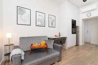 a living room with a couch and a table at Kraków Studio Wawrzyńca by Noclegi Renters in Kraków