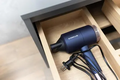 a blow dryer in a cupboard with at Kraków Studio Wawrzyńca by Noclegi Renters in Kraków