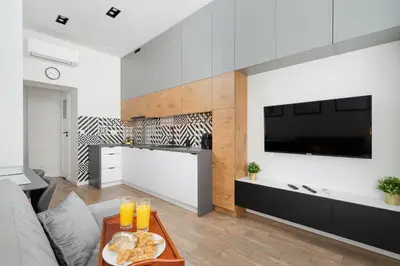 a living room with a couch and a table at Kraków Studio Wawrzyńca by Noclegi Renters in Kraków