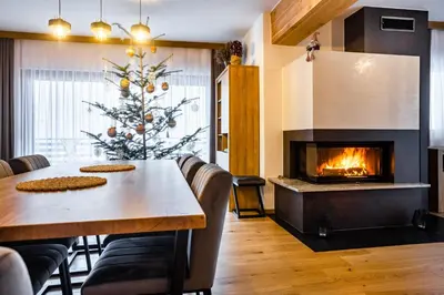 a dining room with a christmas tree and a fireplace at Domek Kordoń SPA Jacuzzi & Sauna in Zubrzyca Górna