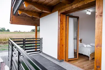 a bedroom on the balcony of a house at Domek Kordoń SPA Jacuzzi & Sauna in Zubrzyca Górna