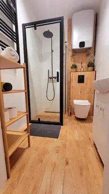 a bathroom with a shower with a glass door at Apartament Joanna in Wadowice