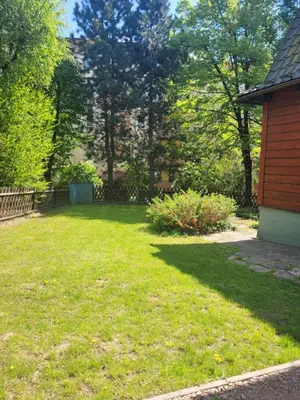 a yard with green grass and a house at Apartament Joanna in Wadowice