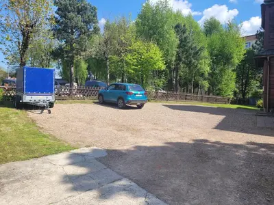 a blue car parked next to a blue truck at Apartament Joanna in Wadowice