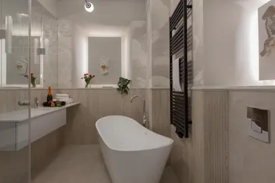 a bathroom with a white toilet and a sink at Colorful 2-bed, 100sqm apartment in the heart of Kazimierz in Kraków