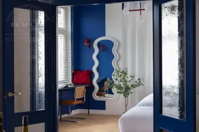 a bedroom with blue walls and a desk and a chair at Colorful 2-bed, 100sqm apartment in the heart of Kazimierz in Kraków