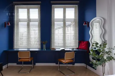 a blue room with two chairs and two windows at Colorful 2-bed, 100sqm apartment in the heart of Kazimierz in Kraków