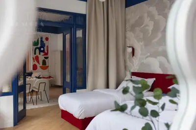 a hotel room with two beds and a table at Colorful 2-bed, 100sqm apartment in the heart of Kazimierz in Kraków