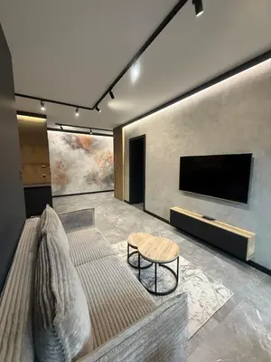 a living room with a couch and a flat screen tv at Deluxe Industrial Apartment free Parking in Kraków