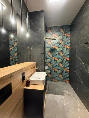 a bathroom with a sink and a wall mural at Deluxe Industrial Apartment free Parking in Kraków
