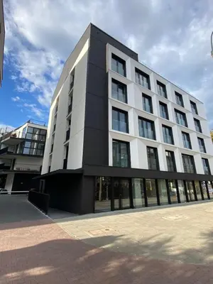 a large white building with a lot of windows at Deluxe Industrial Apartment free Parking in Kraków