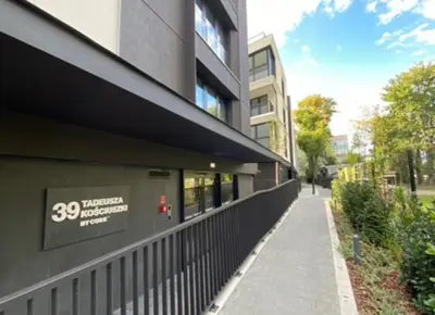 a building with a sign on the side of it at Deluxe Industrial Apartment free Parking in Kraków