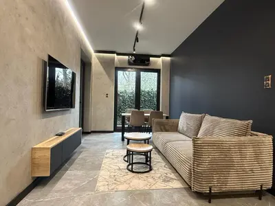 a living room with a couch and a table at Deluxe Industrial Apartment free Parking in Kraków