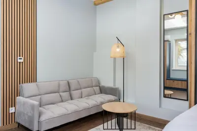 a living room with a couch and a table at Dietla ANTA Apartment in Kraków