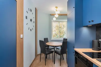 a kitchen with a table and chairs and a window at Dietla ANTA Apartment in Kraków