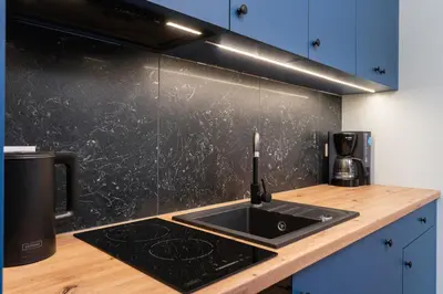 a kitchen with a sink and a counter top at Dietla ANTA Apartment in Kraków