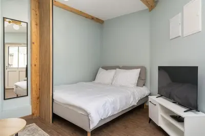 a bedroom with a bed and a mirror at Dietla ANTA Apartment in Kraków