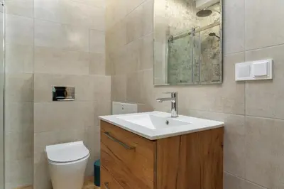a bathroom with a sink and a toilet at Dietla ANTA Apartment in Kraków