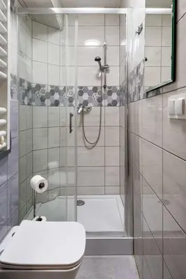a bathroom with a shower with a toilet and a sink at Pokoje na Sowiej in Kraków