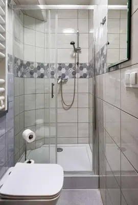 a bathroom with a shower with a toilet and a sink at Pokoje na Sowiej in Kraków