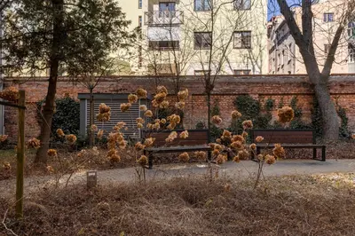a group of chickens sitting on a park bench at ANTA Apartments Plac na Groblach in Kraków