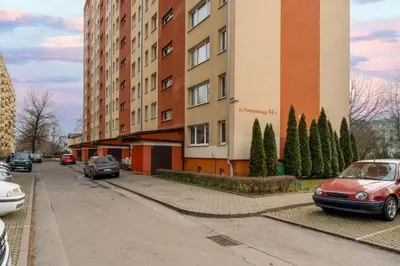 a red car parked in front of a building at Pachońskiego Urban Chic Apartment by BookingHost in Kraków