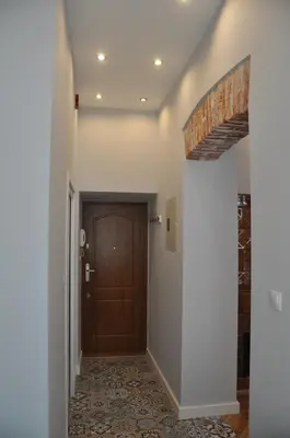 a hallway with a wooden door in a house at Krakowsky Apartment in Kraków