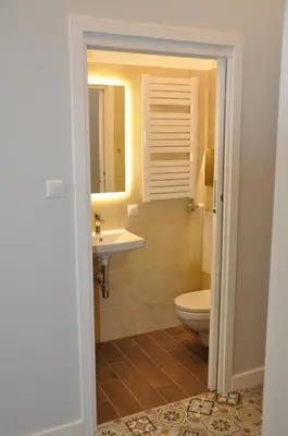 a bathroom with a toilet and a sink at Krakowsky Apartment in Kraków