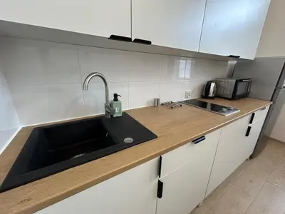 a kitchen with a sink and a counter top at Old Town - 2 bedrooms Sołtyka S3 in Kraków